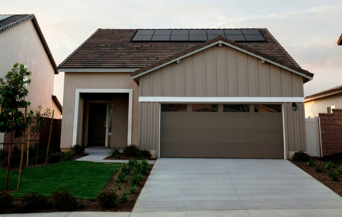 Tan modern home with new garage door